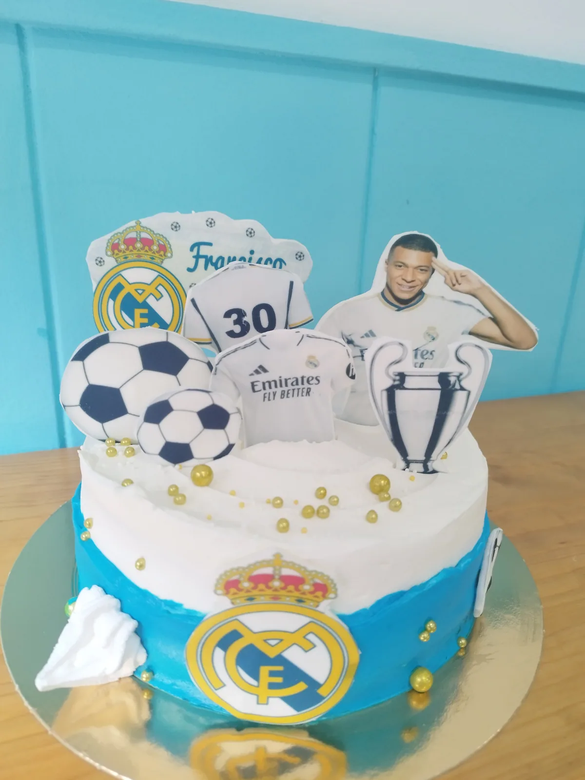 Tarta del Real Madrid en blanco y azul con balones y figura de jugador