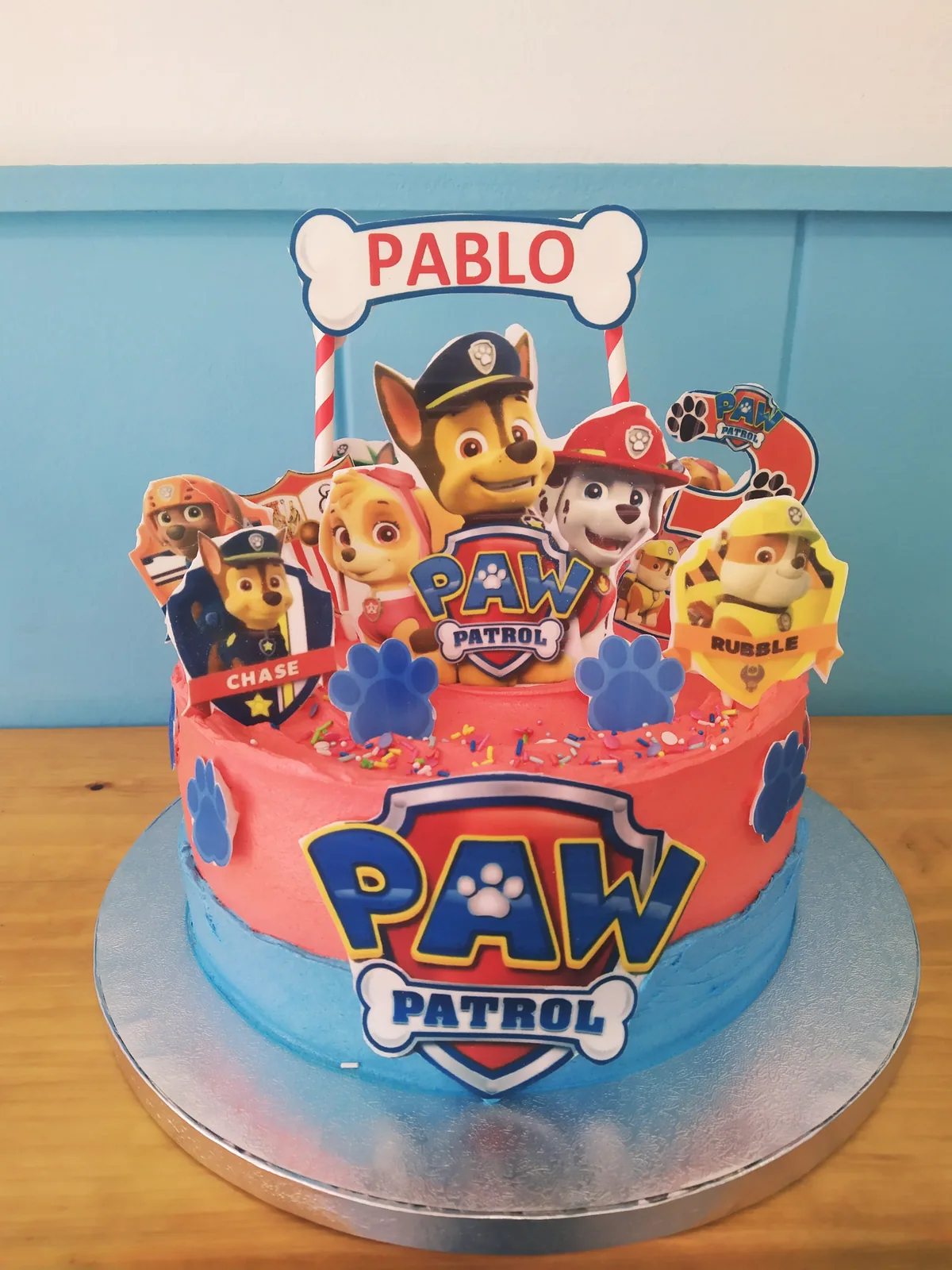 Tarta de la Patrulla Canina en azul con el logo y los cachorros arriba