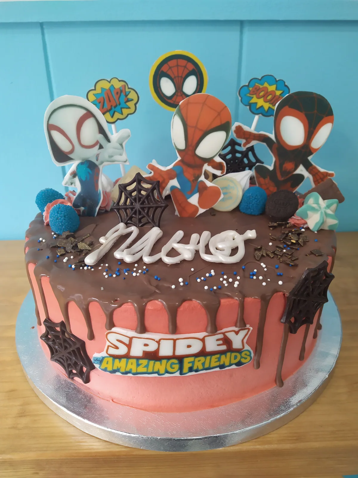 Tarta de Spiderman en rosa y azul con drip de chocolate y arañas